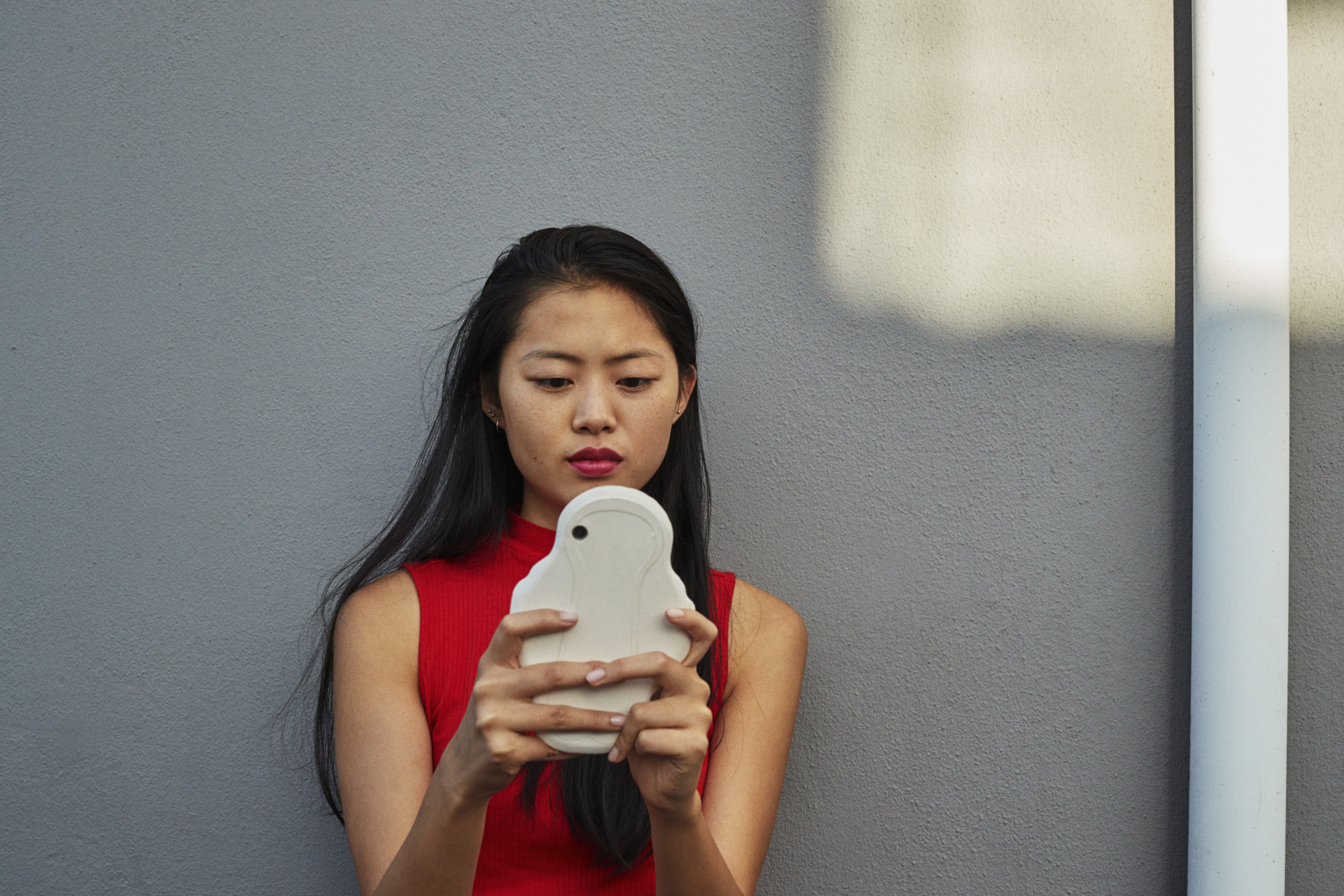 Girl holding pad shaped phone case